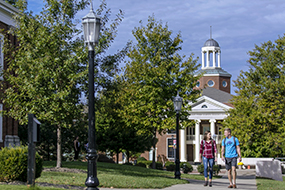student walking across campus